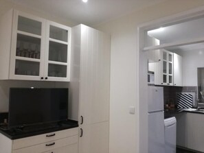 Enjoy cooking in this well-equipped kitchen with a stove and refrigerator.
