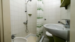 A bathroom with a shower, two sinks, and a toilet. - Rooms Pile - Double Room with Patio (Dubrovnik)