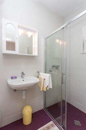 A bathroom with a white sink, mirror, and glass shower enclosure. - Guest House Oreb - One Bedroom Apt with Terrace and Sea View (Kolocep)