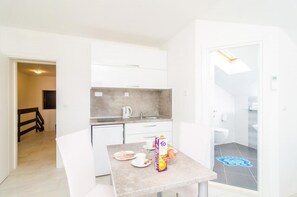 Cozy apartment with a compact living area, kitchenette, and bathroom.
