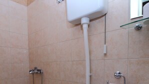 A bathroom with a toilet, a sink, and a shower. - Apartments Magda- Backside Studio Apartment (Cavtat)