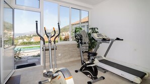 A home gym with an elliptical, a stationary bike, and a treadmill. - Villa Bell Memories- Two Bedroom Apartment with Shared Terrace and Sea View (Cavtat)