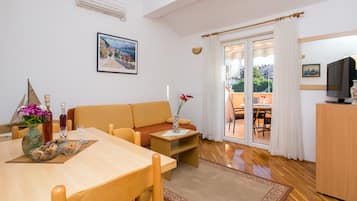 Apartment, 1 Bedroom, Balcony, Garden View | Living area | 42-inch flat-screen TV with cable channels, TV