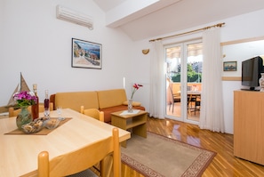 Apartment, 1 Bedroom, Balcony, Garden View | Living area | 42-inch flat-screen TV with cable channels, TV
