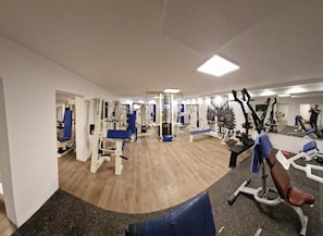 A gym with various exercise equipment, including weight machines and cardio machines. - Eventhof Platzhirsch (Gaggenau)