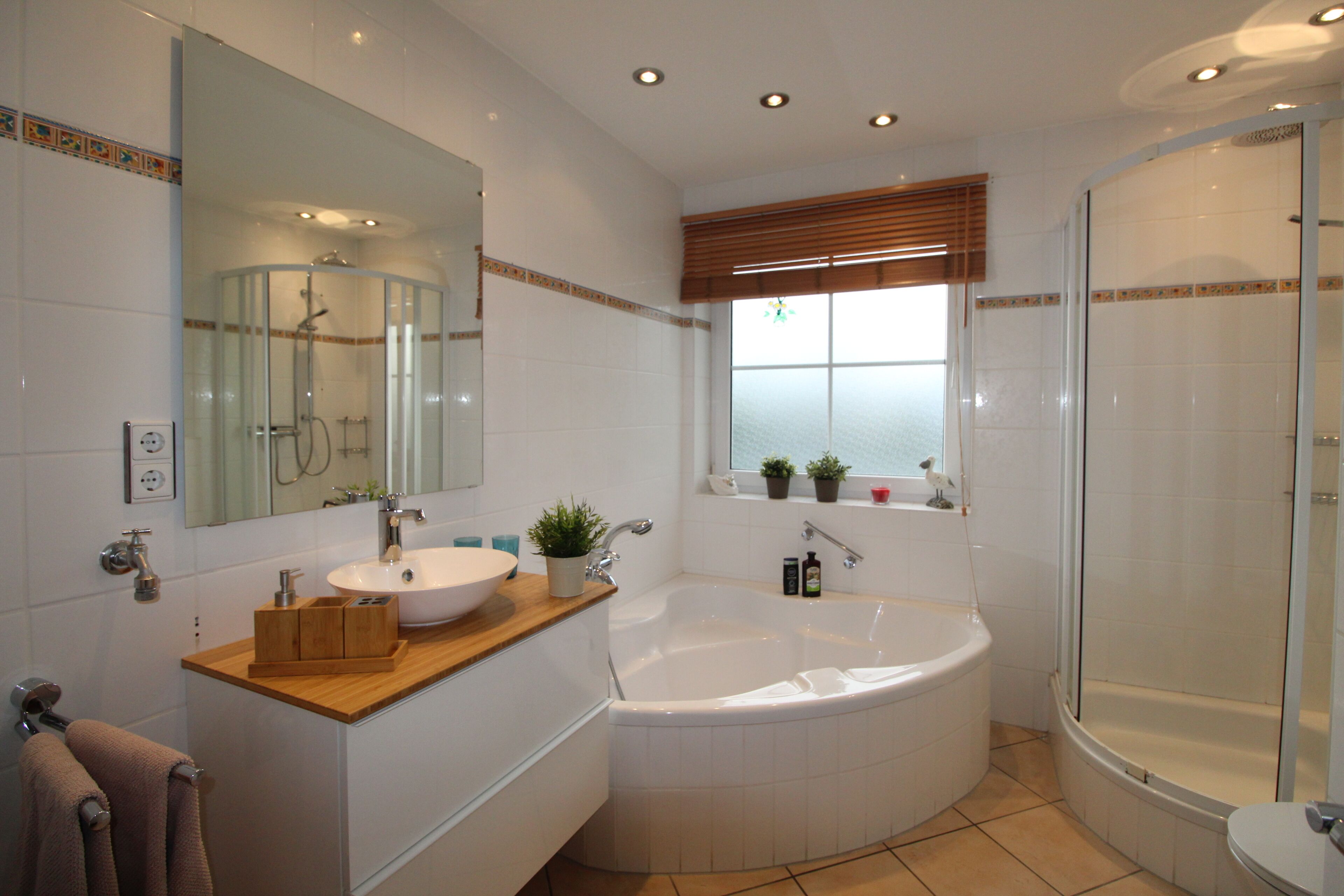 Bathtub, hair dryer, towels, toilet paper