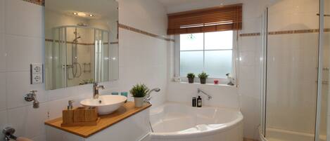 Bathtub, hair dryer, towels, toilet paper
