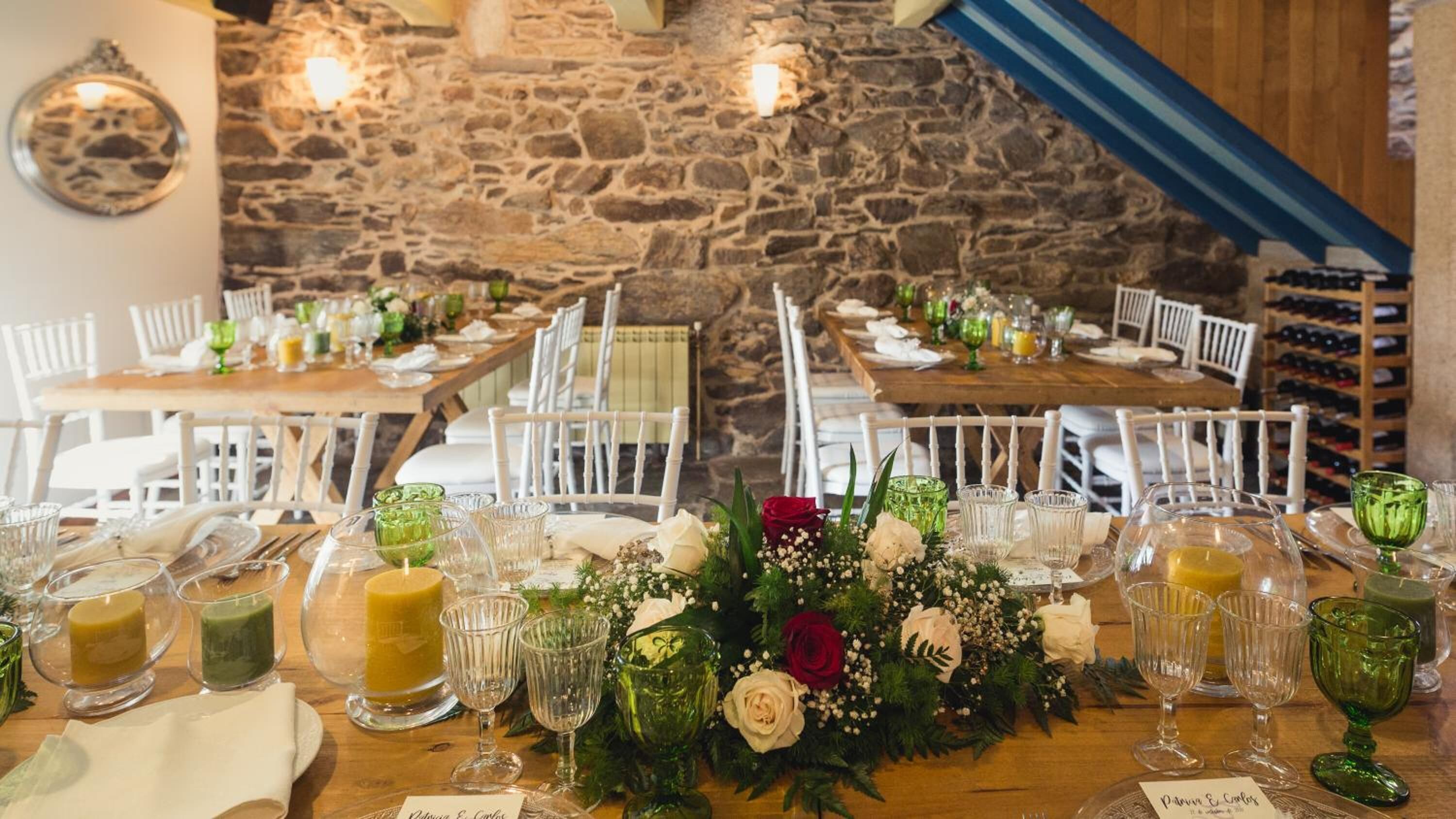 A dining area with stone walls and wooden tables set for a meal.
