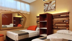 A hotel room with two beds, a large mirror, a wooden headboard, and a painting of a pyramid. - Kaban 44 Hotel (Playa del Carmen)