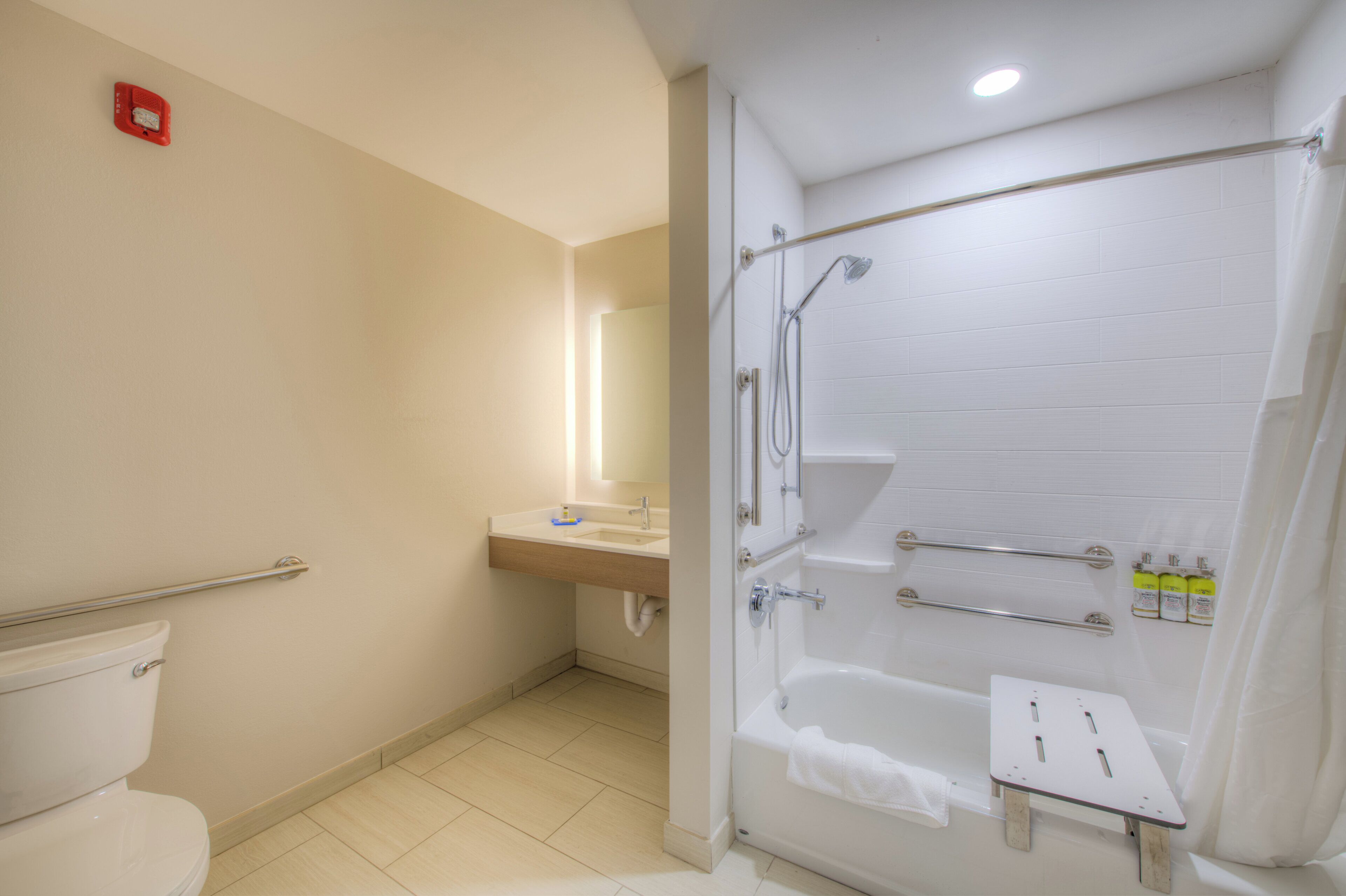 A modern bathroom with a toilet, sink, shower, and bathtub.