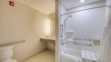 A modern bathroom with a toilet, sink, shower, and bathtub.