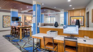 A public computer area with desks, chairs, a printer, and a monitor. - Holiday Inn Express & Suites Remington by IHG (Remington)