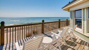 A wooden deck with white chairs overlooking a beach and ocean. - Premier Oceanfront w/ Private Pool, Hot Tub, Elevator, Sauna, Theater, Game Room (Avon)