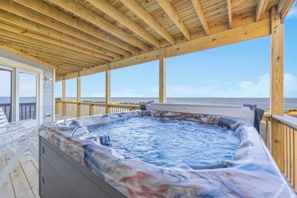 Soak in your private hot tub while watching the ocean waves, feeling the sea breeze under the covered deck. - Premier Oceanfront w/ Private Pool, Hot Tub, Elevator, Sauna, Theater, Game Room (Avon)