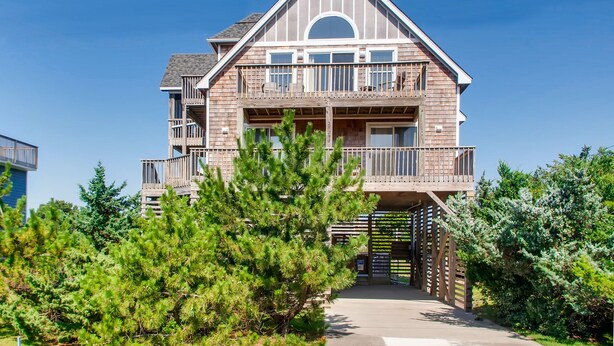 A two-story house with a balcony on the upper floor.