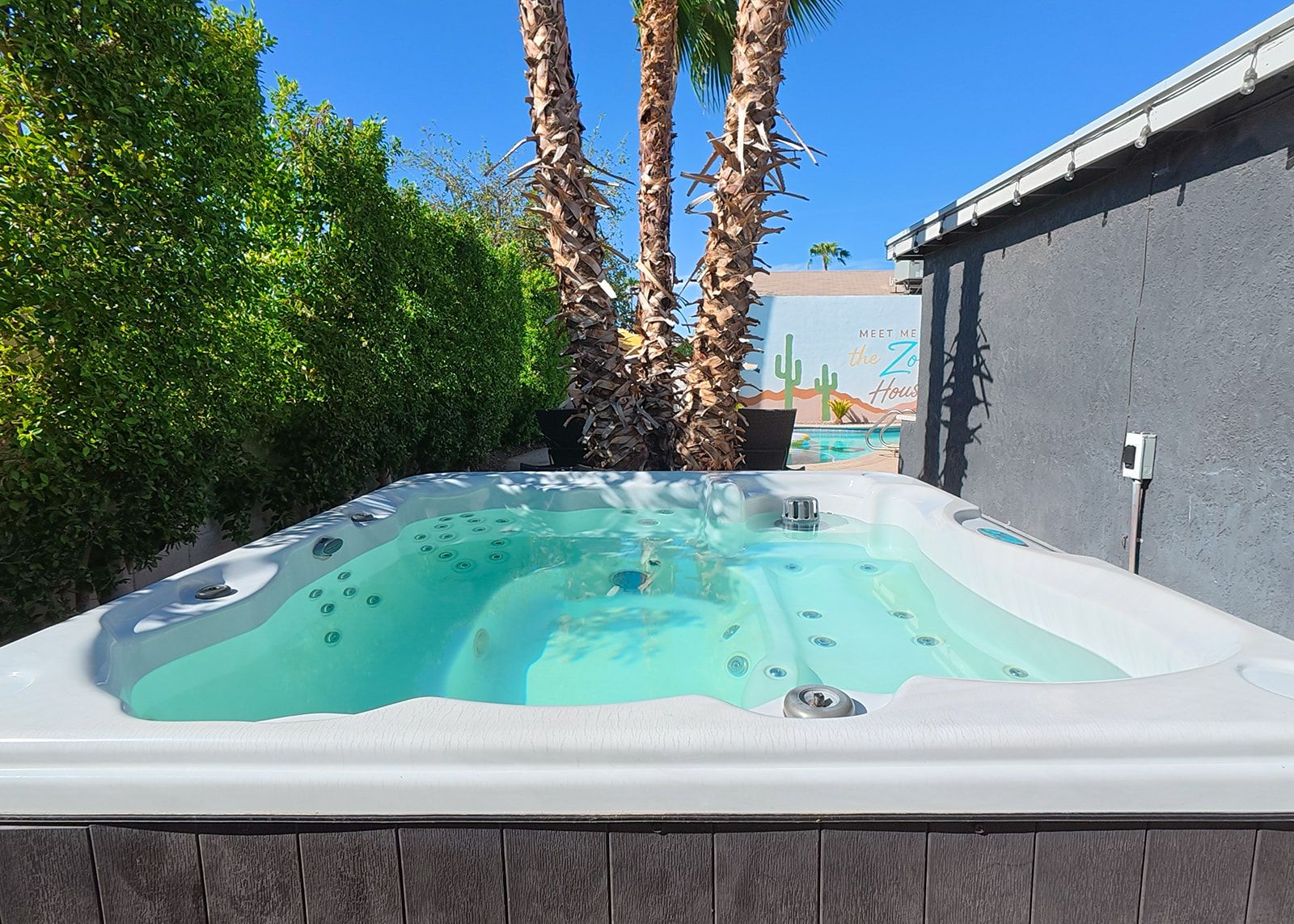 A hot tub with a clear view of the sky and surrounding greenery.