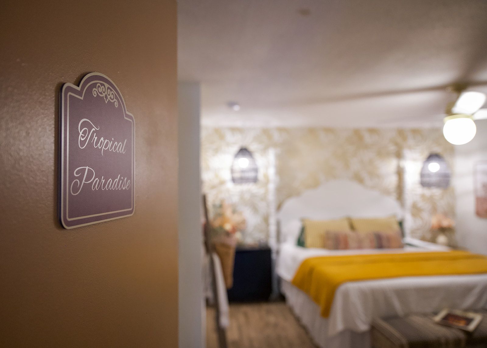 Une chambre d’hôtel avec un lit, une table de chevet et un panneau sur le mur.