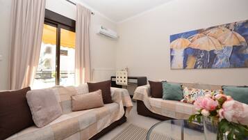 Comfort Apartment | Living area | 42-inch Smart TV with cable channels, TV, iPod dock