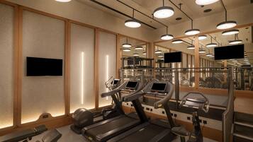 A modern gym with treadmills, exercise bikes, and a mirrored wall.