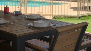 An outdoor dining area with a pool in the background. - Cntrl Tucson Home, Salt Water Pool, Hot Tub, Bike Path, 3mi to UofA TPT 20128463 (Tucson)