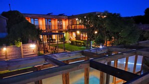 A multi-story building with a pool area visible through a glass barrier. - Ruka Antu Ecolodge (Cobquecura)