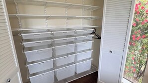 A storage closet with open shelves and multiple storage bins. - Magnificent Canyon View, Huge Deck, Outdoor Dining (San Rafael)