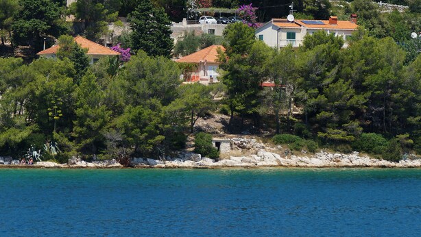 A coastal property with multiple buildings, a rocky shoreline, and clear blue water. - Seafront Apartment Dana - Two Bedroom Apartment with Terrace and Sea View (Vela Luka)