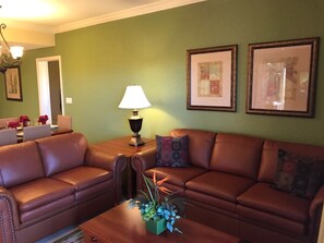Cozy living space with a sofa, armchair, and dining area, perfect for socializing and relaxation.