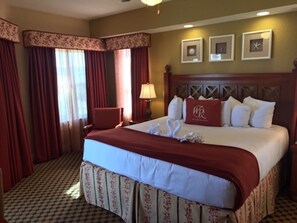 Cozy retreat with a large bed, wooden headboard, and a checkered floor.