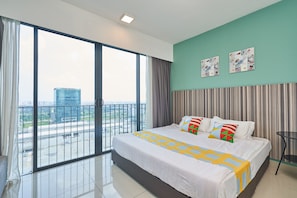 A modern hotel room with a large bed, a view of the city, and a balcony. - OYO Home 44002 Classic 2br Setia Alam Trefoil. (Shah Alam)