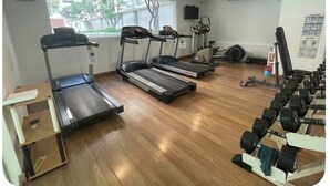 A gym with treadmills, elliptical machines, and a weight bench. - Quiet & Secluded Urban Sanctuary for 2 (Bangkok)
