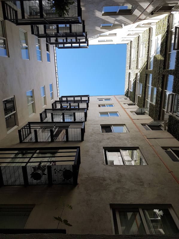 Stunning multi-story building with spacious balconies and lush greenery.