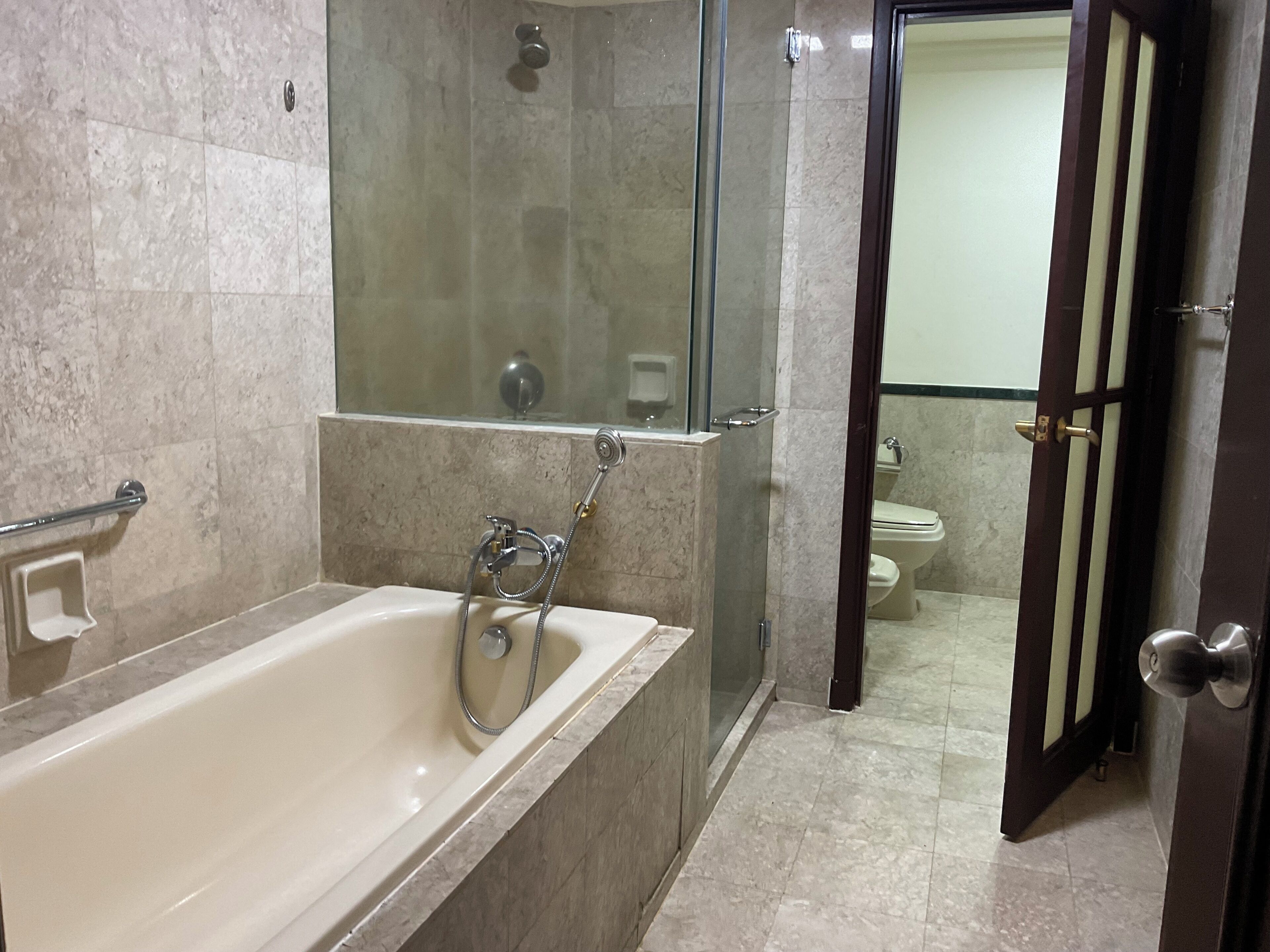 A bathroom with a bathtub, a shower, and a toilet.