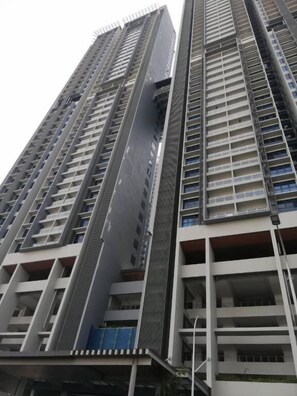 A high-rise building with multiple floors, large windows, and a modern architectural design.