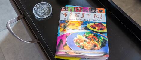 A stack of books titled 'Fiesta! A Celebration of Latin Hospitality' on a black tray.