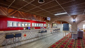 A restaurant with a red counter, bar stools, and a chalkboard menu. - Leichhardt Hotel Motel (Cloncurry)