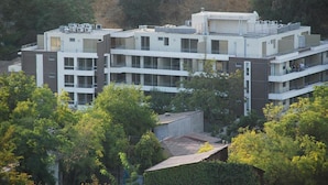 A multi-story building with a modern architectural design, featuring balconies and large windows. - Bellavista Spotlight Apartment (Santiago)