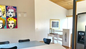 A modern kitchen with a wooden ceiling, a white countertop, and a stainless steel refrigerator. - A spacious house with amazing view (Grafarvogur)
