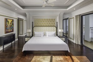 A spacious bedroom with a large bed, two bedside tables with lamps, a ceiling fan, and a large window with curtains. - Meliá Vinpearl Hai Phong Rivera (Hai Phong)