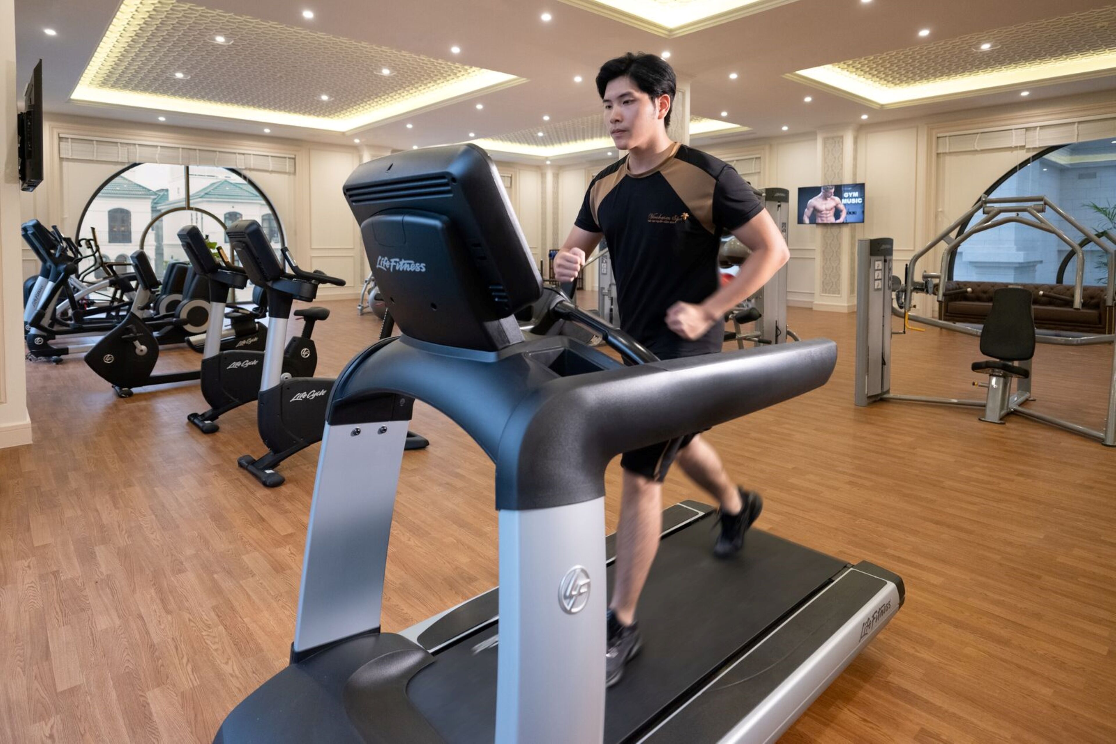 A gym with treadmills, exercise bikes, and weight machines.
