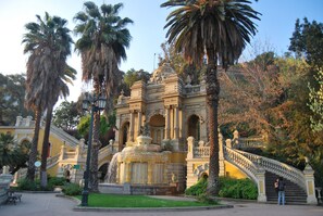 A historic building with ornate architecture, a fountain, and a staircase. - Delightful Downtown Apartment (Santiago)