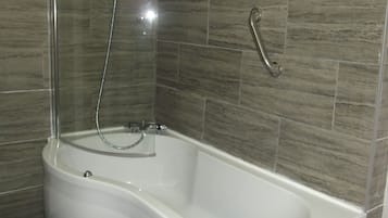Combined shower/bathtub, hair dryer, towels, shampoo
