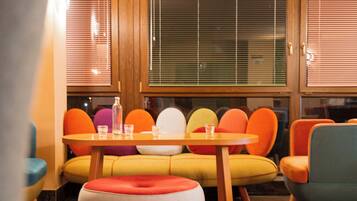 A cozy seating area with a wooden table and colorful chairs.