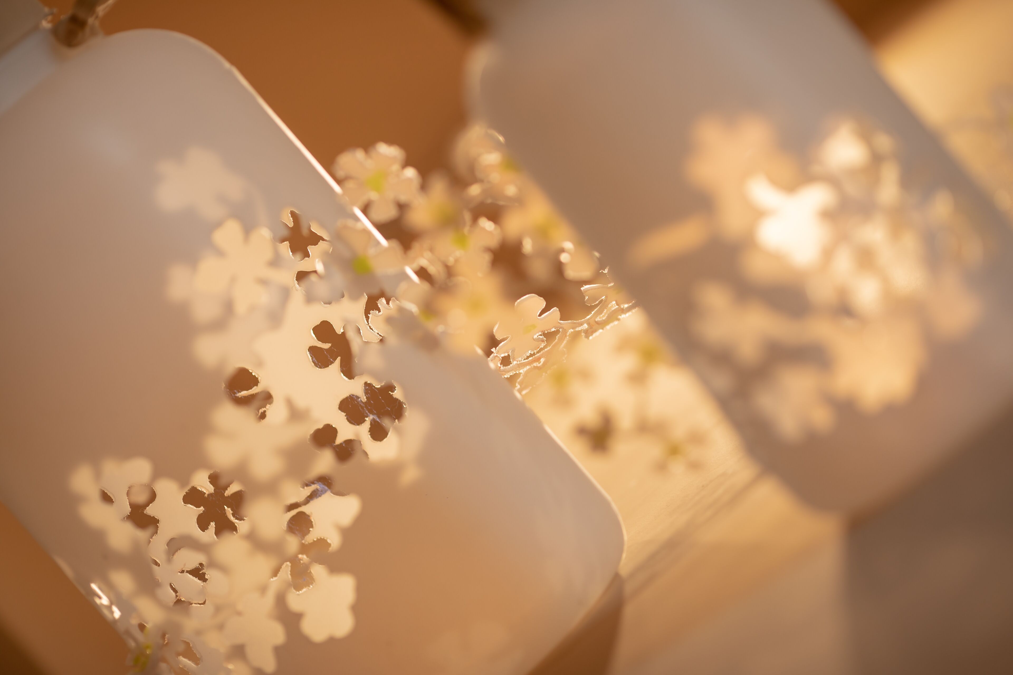 A close-up of a white chair with a floral pattern.