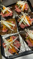 Una bandeja con alimentos, incluyendo carne y verduras.