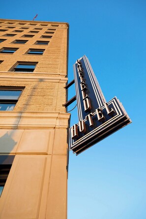 A tall building with a prominent sign reading "Hotel".