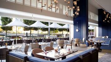 An outdoor dining area with tables, chairs, and umbrellas.