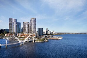 A modern cityscape with high-rise buildings, a bridge over water, and a waterfront area. - The Ritz-Carlton, Perth (Perth)