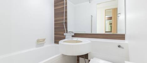 A modern bathroom with a bathtub, sink, and toilet.