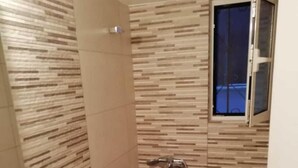 A small bathroom with a toilet, a sink, and a shower. - Lovely Studio in Omonoia (Athens)